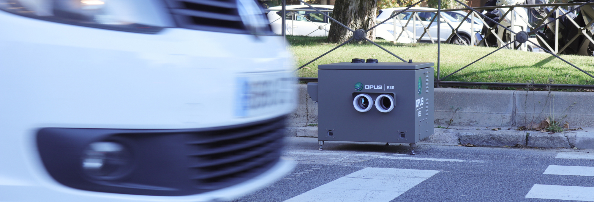 white car passing in front of an opus remote sensing device