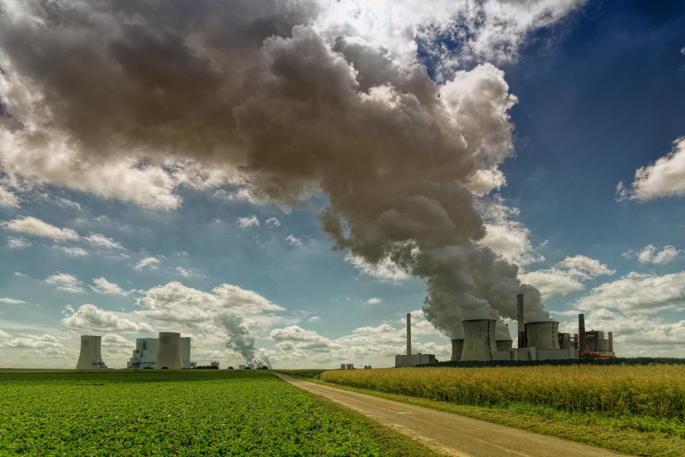 Factory emitting smoke into the atmosphere, illustrating the impact of urban air pollution on worsening allergy symptoms, as highlighted by Opus RSE.