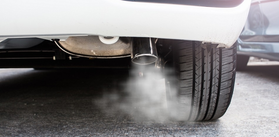 Car exhaust emitting visible smoke, highlighting Opus RSE's role in addressing vehicle emissions amid the EU's investigation into manufacturers involved in an emissions scandal.